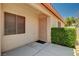View of front porch with stucco walls, security door, and mature shrubbery at 8028 Hurricane Cove Ct, Las Vegas, NV 89129
