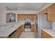 Modern kitchen with stainless steel appliances, including refrigerator and gas range, and breakfast bar at 8028 Hurricane Cove Ct, Las Vegas, NV 89129