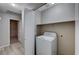 Laundry area featuring a washing machine and shelving for supplies at 8028 Hurricane Cove Ct, Las Vegas, NV 89129