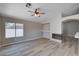 Spacious living room with hardwood floors, a fireplace, and large window with natural light at 8028 Hurricane Cove Ct, Las Vegas, NV 89129