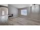 Open living room featuring hardwood floors and a cozy fireplace at 8028 Hurricane Cove Ct, Las Vegas, NV 89129