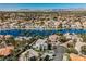 Stunning aerial view of lakefront homes, palm trees, water access and beautiful mountain views at 8133 Desert Jewel Cir, Las Vegas, NV 89128