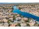 High aerial view showcases homes surrounding a series of winding blue lakes at 8133 Desert Jewel Cir, Las Vegas, NV 89128