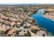 High aerial view showcases the neighborhood's lakeside homes surrounded by lush trees at 8133 Desert Jewel Cir, Las Vegas, NV 89128