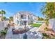Expansive backyard featuring a pool, lounge area, and a cozy fire pit for relaxation at 8133 Desert Jewel Cir, Las Vegas, NV 89128