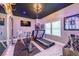 Well-equipped exercise room with treadmill, bike, and ample natural light at 8133 Desert Jewel Cir, Las Vegas, NV 89128