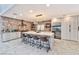 Large kitchen with an oversized island, seating, stainless steel appliances, and tile backsplash at 8133 Desert Jewel Cir, Las Vegas, NV 89128