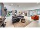 Spacious open-concept living area with staircase, marble floors, modern furnishings, and backyard access at 8133 Desert Jewel Cir, Las Vegas, NV 89128