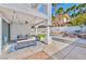Relaxing covered patio with stylish furniture, string lights, and a serene outdoor setting at 8133 Desert Jewel Cir, Las Vegas, NV 89128