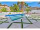 Beautiful backyard pool with in-pool seating and stylish patio with contemporary design at 8133 Desert Jewel Cir, Las Vegas, NV 89128
