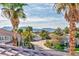 Street view of gorgeous single Gathering homes with palm trees and mountain views in the distance at 8133 Desert Jewel Cir, Las Vegas, NV 89128