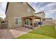 Outdoor living area with a covered patio, dining set, and low-maintenance landscaping at 8316 Gold River Ct, Las Vegas, NV 89113