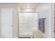 Modern bathroom featuring a glass-enclosed shower with tiled walls and a shower bench at 8316 Gold River Ct, Las Vegas, NV 89113