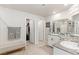 Spacious bathroom with double sinks, granite countertops, and walk-in closet leading to powder room and shower at 8316 Gold River Ct, Las Vegas, NV 89113