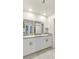 Bathroom with double sinks, granite countertops, white cabinets, and modern lighting at 8316 Gold River Ct, Las Vegas, NV 89113