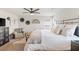 Well-lit bedroom showcasing a metal bed frame and cozy sitting area with neutral decor at 8316 Gold River Ct, Las Vegas, NV 89113