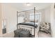 Inviting bedroom with a canopy bed, patterned accent chair, and ottomans for a relaxing space at 8316 Gold River Ct, Las Vegas, NV 89113