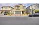 Charming two-story home features a brick driveway, manicured landscaping, and attached two-car garage at 8316 Gold River Ct, Las Vegas, NV 89113