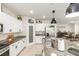Beautiful kitchen features white cabinets, granite countertops, stainless steel appliances, and a view into the dining area at 8316 Gold River Ct, Las Vegas, NV 89113