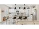 Bright kitchen features white cabinets, granite countertops, stainless steel appliances, and an island with barstool seating at 8316 Gold River Ct, Las Vegas, NV 89113