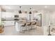 Contemporary kitchen with a large island, white cabinetry, stainless steel appliances, and tiled flooring at 8316 Gold River Ct, Las Vegas, NV 89113