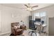 Comfortable home office space with a ceiling fan, desk, and large executive chair at 8316 Gold River Ct, Las Vegas, NV 89113