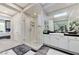 Bright bathroom featuring a glass enclosed shower, dual sink vanity and large mirrors at 8340 Carmel Ridge Ct, Las Vegas, NV 89113