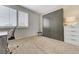 Bright bedroom featuring a built-in wardrobe, neutral carpet, and a large window for natural light at 8340 Carmel Ridge Ct, Las Vegas, NV 89113