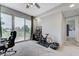 Bright bedroom featuring an exercise bike and access to a balcony at 8340 Carmel Ridge Ct, Las Vegas, NV 89113