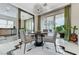 Contemporary dining area with a modern chandelier, tile floors, and views of the backyard at 8340 Carmel Ridge Ct, Las Vegas, NV 89113