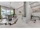 Elegant dining area with modern chandelier, neutral tones, and sliding glass doors to the backyard at 8340 Carmel Ridge Ct, Las Vegas, NV 89113