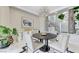 Bright dining room featuring modern lighting, a round table, and stylish decor leading to entry at 8340 Carmel Ridge Ct, Las Vegas, NV 89113