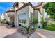 Stucco home exterior with balcony, patio, desert landscaping, and sliding glass doors at 8340 Carmel Ridge Ct, Las Vegas, NV 89113