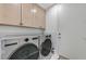 Well-organized laundry room with washer, dryer, and ample cabinet storage space at 8340 Carmel Ridge Ct, Las Vegas, NV 89113