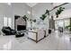 Bright and airy living room with high ceilings, tile floors, and large windows with plantation shutters at 8340 Carmel Ridge Ct, Las Vegas, NV 89113