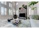 Bright living room featuring high ceilings, tile floors, a decorative fireplace, and modern furnishings at 8340 Carmel Ridge Ct, Las Vegas, NV 89113