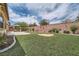 Expansive backyard featuring well-maintained artificial turf and desert landscaping at 8431 Jeremiah Grove St, Las Vegas, NV 89123
