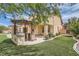 Beautiful backyard with a built-in grill, covered patio, artificial grass, and manicured landscaping at 8431 Jeremiah Grove St, Las Vegas, NV 89123