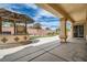 Inviting backyard patio featuring an outdoor kitchen with a built-in grill and landscaped yard at 8431 Jeremiah Grove St, Las Vegas, NV 89123