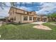 Spacious backyard features artificial turf, a built-in grill, a covered patio, and mature landscaping at 8431 Jeremiah Grove St, Las Vegas, NV 89123