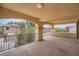 Spacious covered balcony with stone arches and wrought iron railing overlooking the outdoor view at 8431 Jeremiah Grove St, Las Vegas, NV 89123