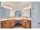 Bathroom featuring a double sink vanity with large mirrors and decorative lighting at 8431 Jeremiah Grove St, Las Vegas, NV 89123