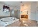 Primary bathroom featuring large tub, glass shower, and & sinks at 8431 Jeremiah Grove St, Las Vegas, NV 89123