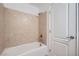 Bright bathroom featuring tub with shower and decorative tile surround at 8431 Jeremiah Grove St, Las Vegas, NV 89123