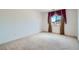 Empty bedroom featuring carpeted floors and a window with decorative curtains at 8431 Jeremiah Grove St, Las Vegas, NV 89123