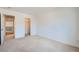 Empty carpeted bedroom with an open door and walk-in closet at 8431 Jeremiah Grove St, Las Vegas, NV 89123