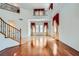 Elegant foyer featuring hardwood floors, grand staircase, and large windows creates a welcoming and bright entrance at 8431 Jeremiah Grove St, Las Vegas, NV 89123