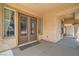 Inviting entryway featuring double doors with glass inserts, complemented by a covered porch and neutral tones at 8431 Jeremiah Grove St, Las Vegas, NV 89123