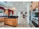 Open kitchen with stainless steel appliances, granite countertops, and a center island at 8431 Jeremiah Grove St, Las Vegas, NV 89123