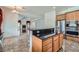 Bright kitchen featuring stainless steel appliances, dark granite countertops and a central island at 8431 Jeremiah Grove St, Las Vegas, NV 89123